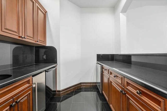 kitchen featuring decorative backsplash and dark tile patterned flooring