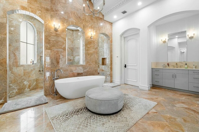 bathroom with vanity, a notable chandelier, and independent shower and bath