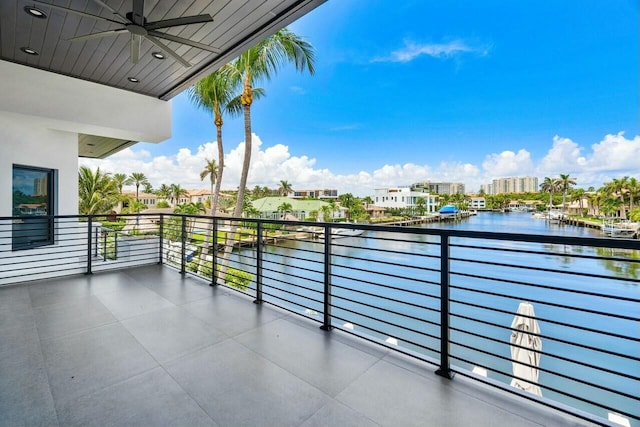 balcony with ceiling fan and a water view