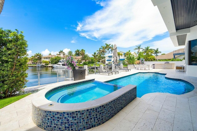 view of pool featuring a water view, an in ground hot tub, and a patio