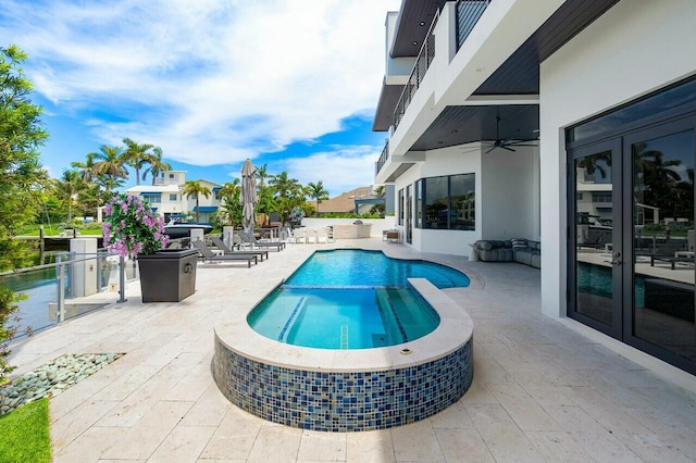 view of pool with ceiling fan, french doors, a patio area, and an in ground hot tub