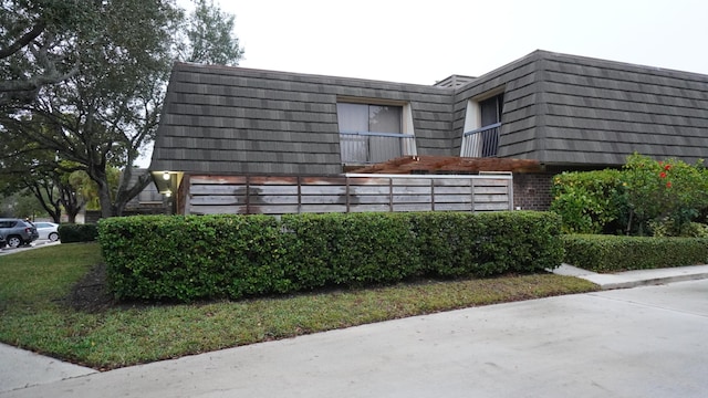 view of side of home with a balcony