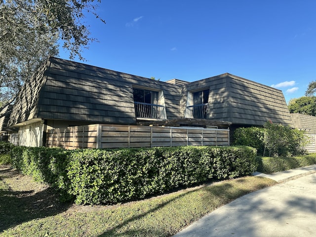 view of side of home with a balcony