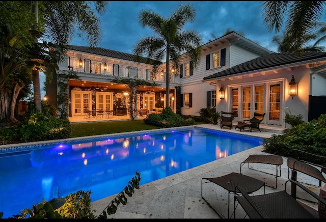 rear view of property with a patio area and a balcony