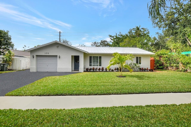 ranch-style house featuring a garage and a front lawn