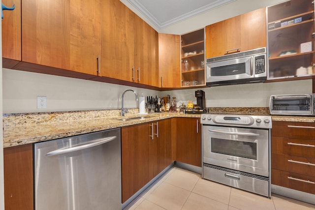 kitchen featuring sink, stainless steel appliances, light stone counters, and crown molding