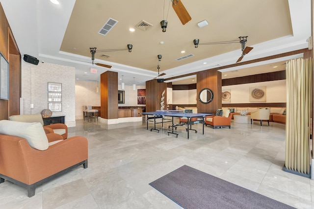 game room featuring a tray ceiling