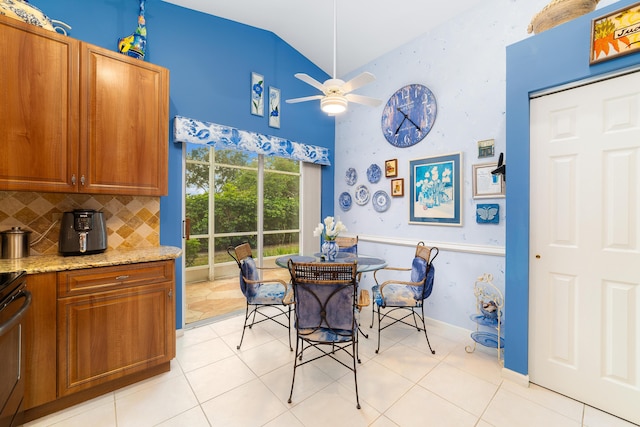 dining room with lofted ceiling, light tile patterned floors, and ceiling fan