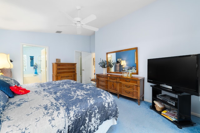 bedroom with vaulted ceiling, ceiling fan, ensuite bathroom, and carpet flooring