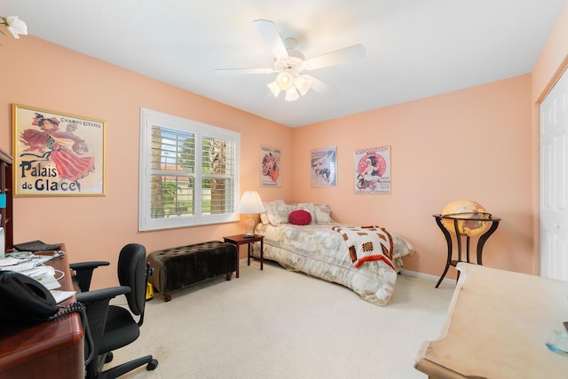 carpeted bedroom with ceiling fan and a closet