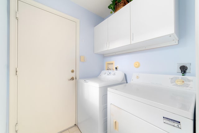 laundry area featuring cabinets and washer and clothes dryer