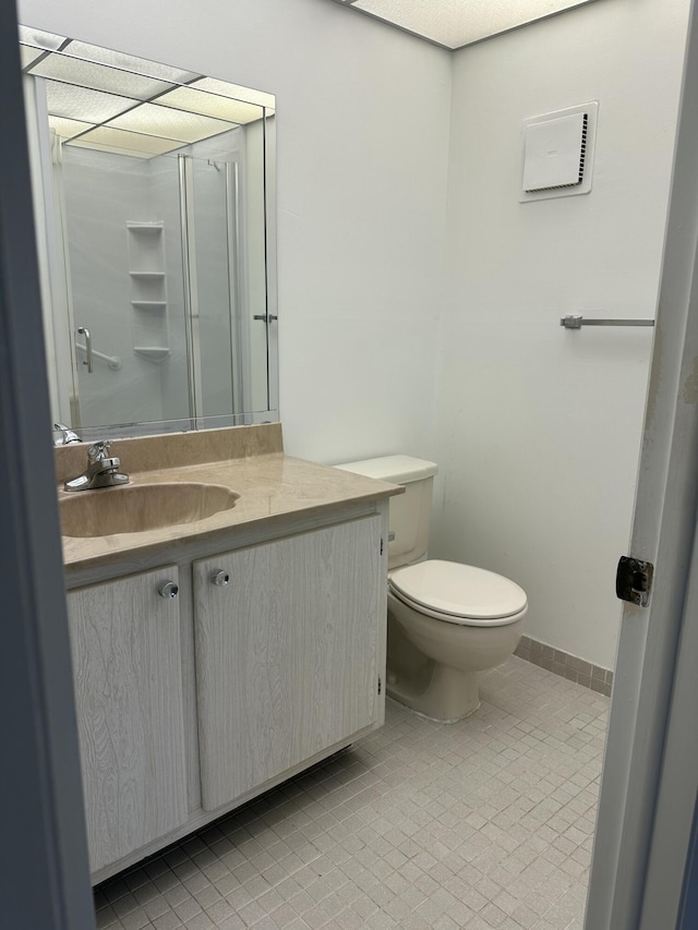 bathroom with toilet, tile patterned flooring, and vanity