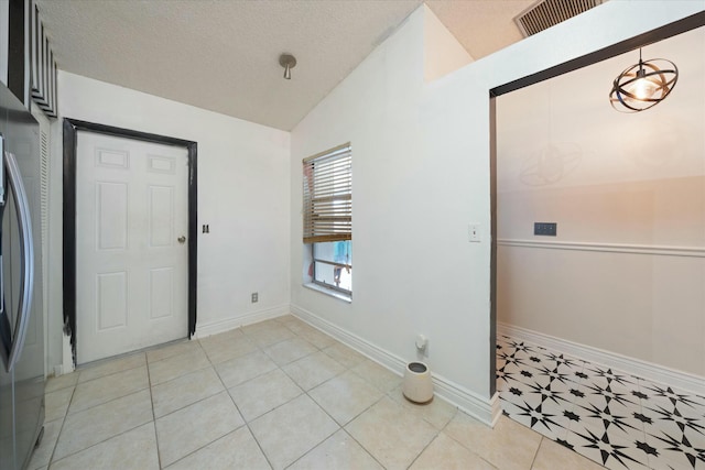 tiled entrance foyer featuring vaulted ceiling