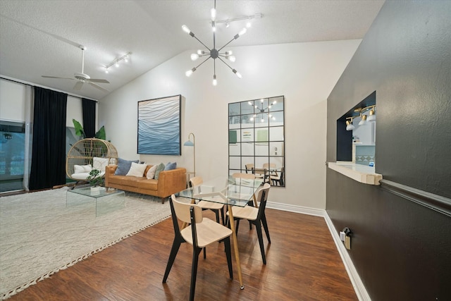 dining space featuring a textured ceiling, vaulted ceiling, ceiling fan with notable chandelier, and dark hardwood / wood-style floors