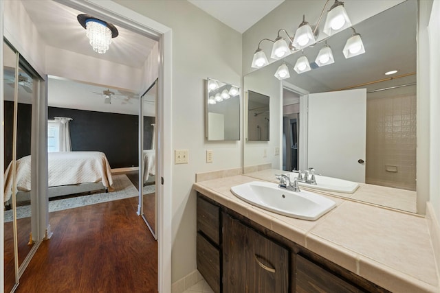 bathroom with ceiling fan, hardwood / wood-style floors, and vanity