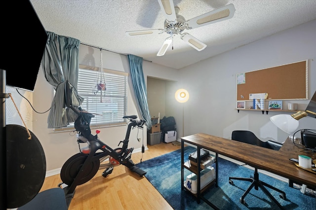 office with ceiling fan, a textured ceiling, and hardwood / wood-style flooring