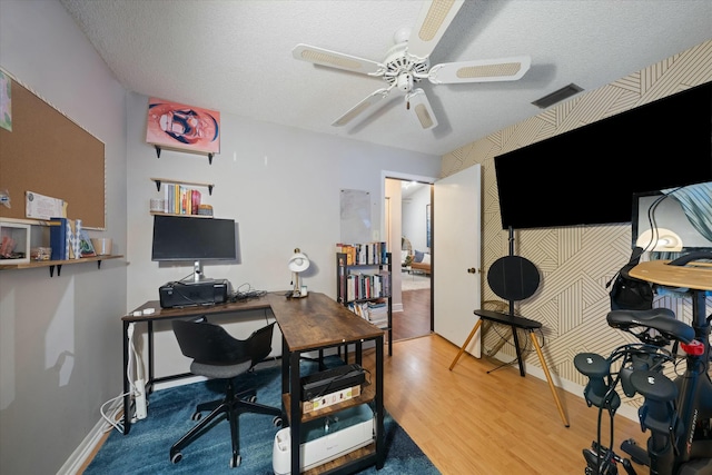 office area with wood-type flooring, a textured ceiling, and ceiling fan