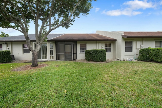 rear view of property with a yard