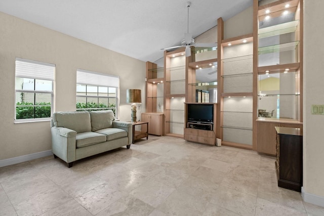 living room featuring ceiling fan and vaulted ceiling