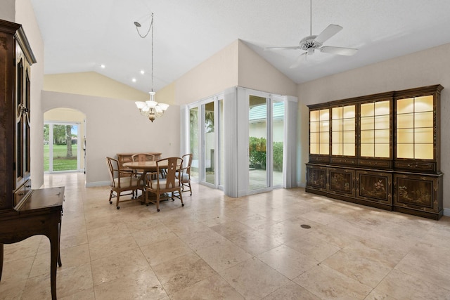 tiled dining room with vaulted ceiling and ceiling fan with notable chandelier