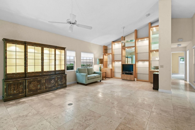 unfurnished room with ceiling fan and high vaulted ceiling