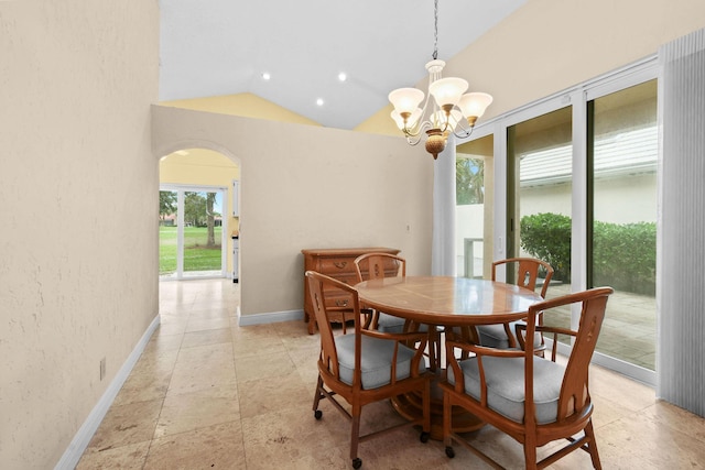 dining room with an inviting chandelier and vaulted ceiling