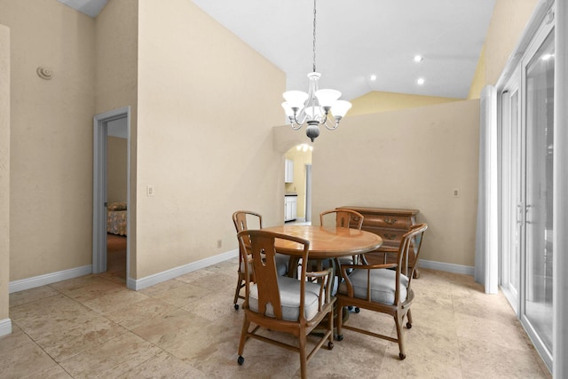 dining room with lofted ceiling and a notable chandelier