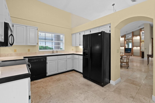 kitchen featuring white cabinetry, vaulted ceiling, sink, and black appliances