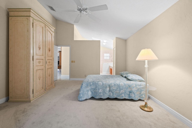 bedroom featuring ensuite bath, vaulted ceiling, light colored carpet, and ceiling fan