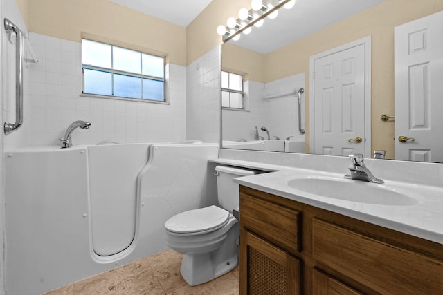 bathroom featuring vanity, toilet, tile patterned flooring, and a washtub