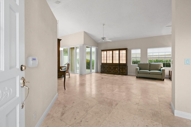 foyer with ceiling fan and lofted ceiling