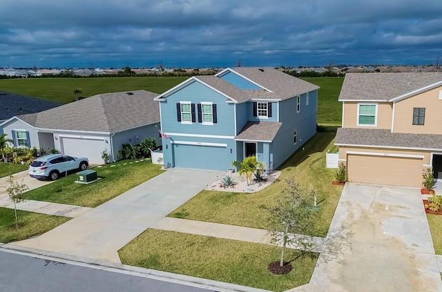 view of property featuring a garage and a front lawn