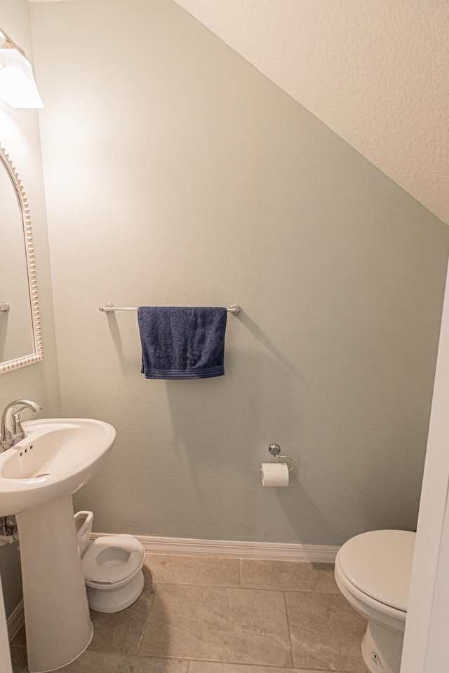 bathroom featuring tile patterned floors and toilet