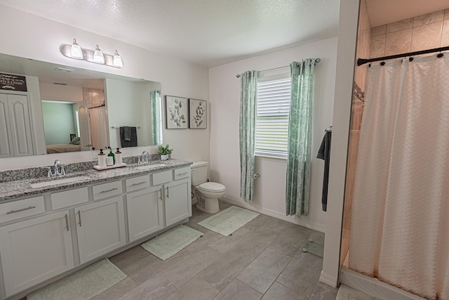 bathroom featuring vanity, toilet, and a shower with shower curtain