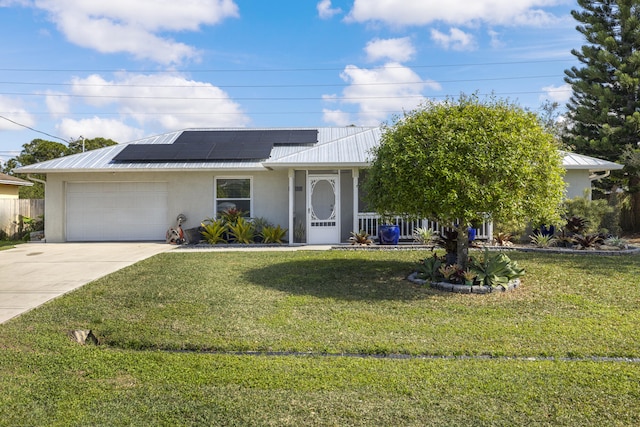 ranch-style house with a garage, a front yard, and solar panels