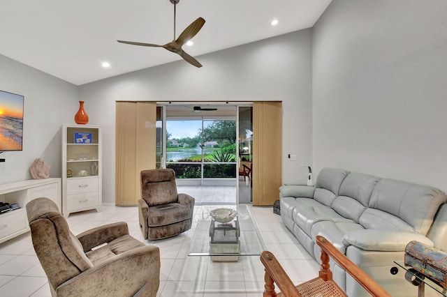 tiled living room with high vaulted ceiling and ceiling fan