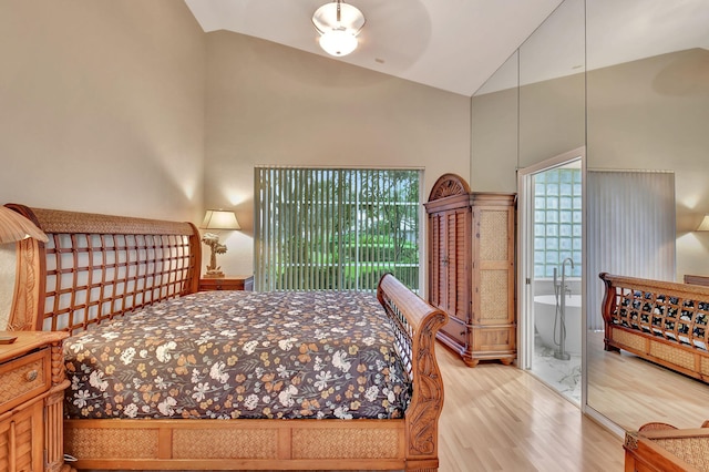 bedroom featuring ceiling fan, wood-type flooring, and high vaulted ceiling