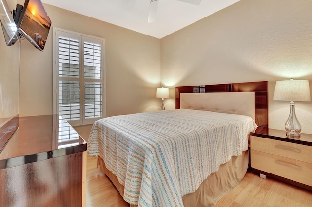 bedroom with ceiling fan and light hardwood / wood-style floors