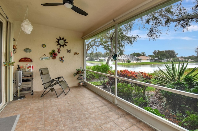 sunroom with a water view and a ceiling fan