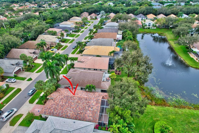 drone / aerial view with a residential view and a water view