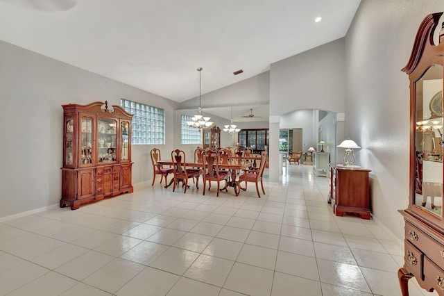 dining area with visible vents, high vaulted ceiling, an inviting chandelier, light tile patterned floors, and baseboards