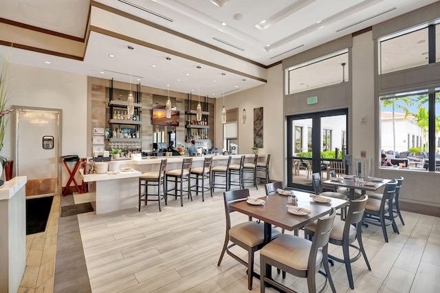 dining area featuring french doors and a high ceiling