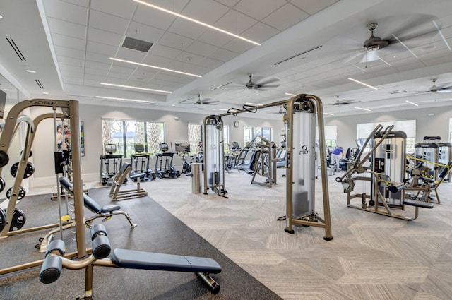 exercise room with light colored carpet and a drop ceiling