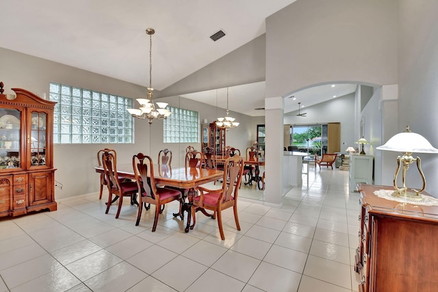 dining room with a notable chandelier, visible vents, light tile patterned floors, and high vaulted ceiling