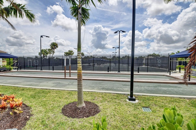 exterior space with a yard and tennis court