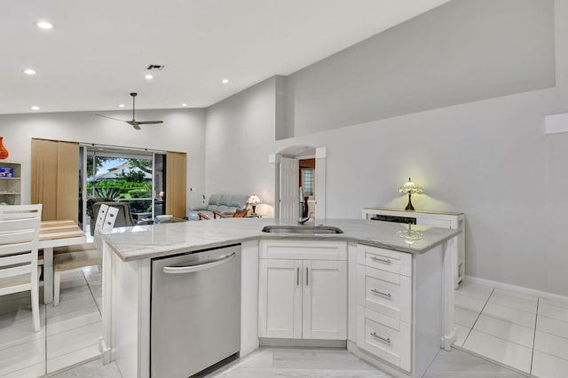 kitchen featuring light stone counters, a center island with sink, vaulted ceiling, dishwasher, and open floor plan