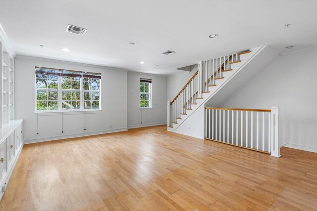 interior space featuring ornamental molding and light hardwood / wood-style flooring