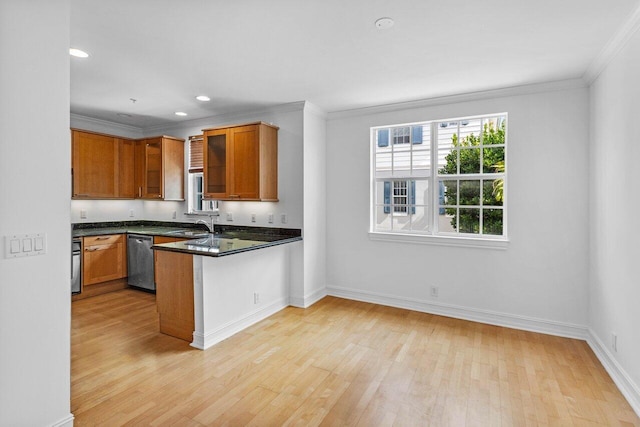 kitchen featuring sink, light hardwood / wood-style flooring, stainless steel dishwasher, ornamental molding, and kitchen peninsula