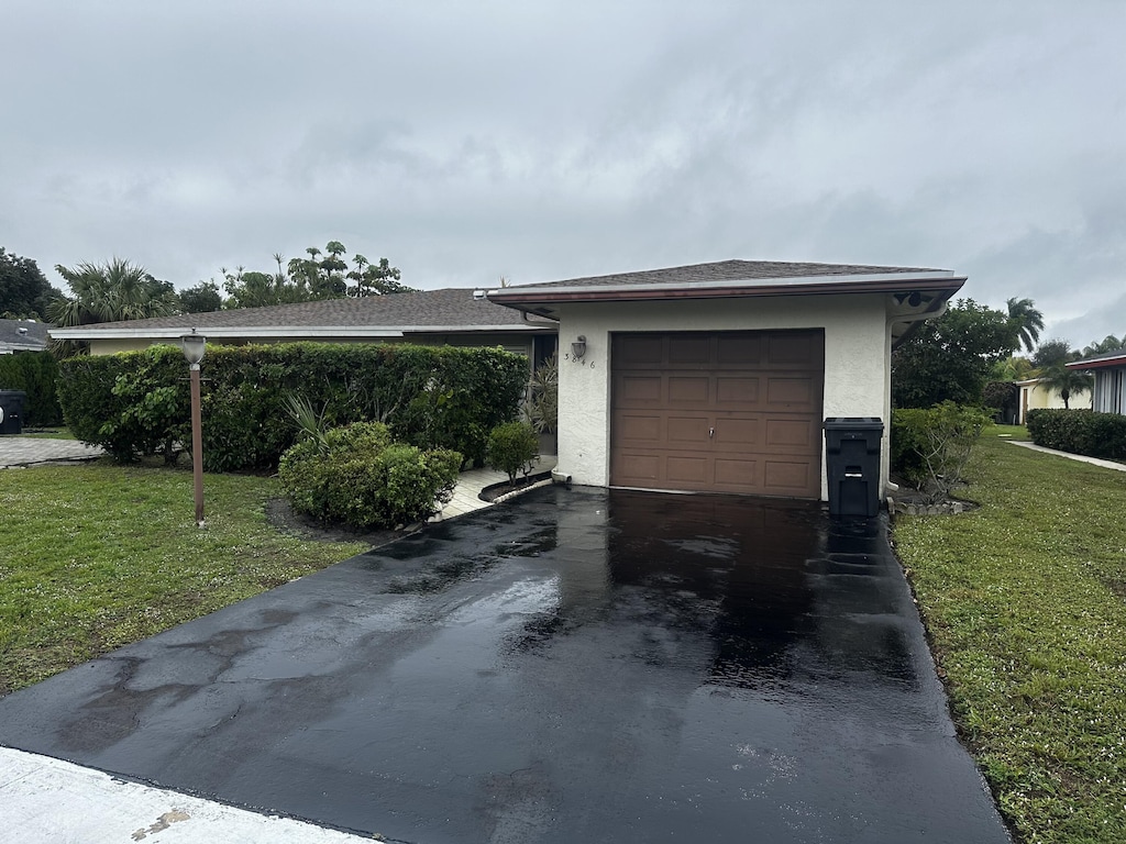 garage featuring a lawn