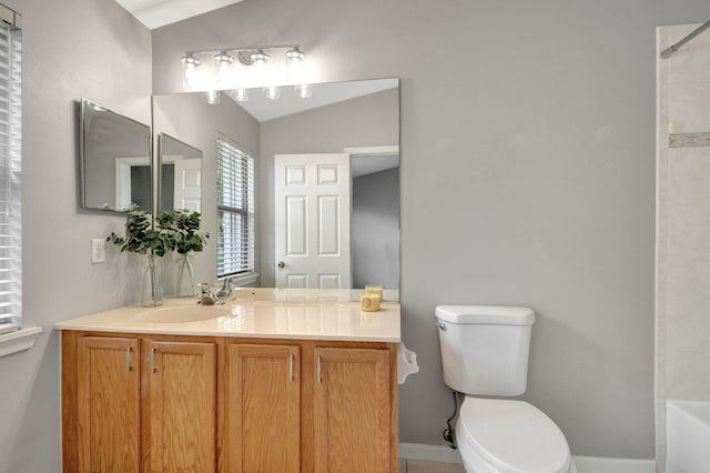 bathroom featuring toilet, vanity, and lofted ceiling